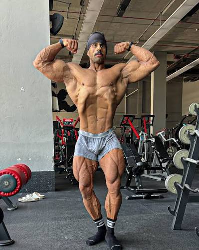 Abu Rabiea posing by training equipment